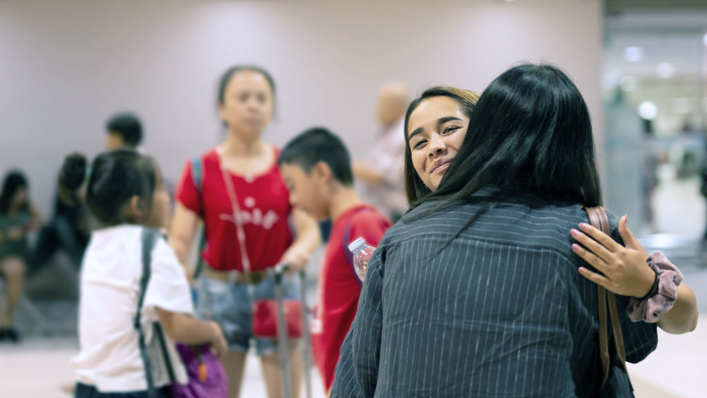 Borders Law Firm Citizenship family hugging at border